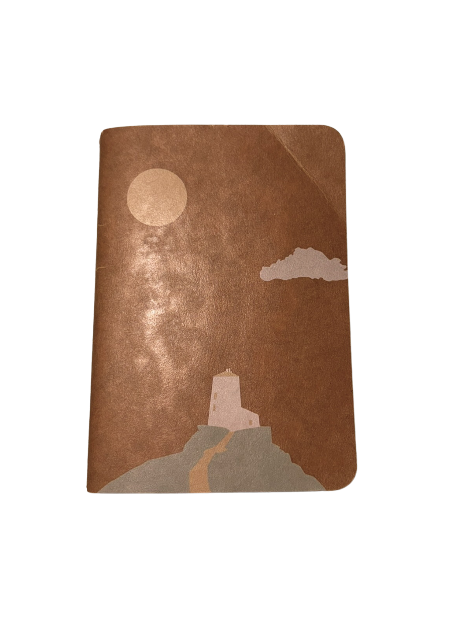 Notebook with a lighthouse and moon design on a brown background